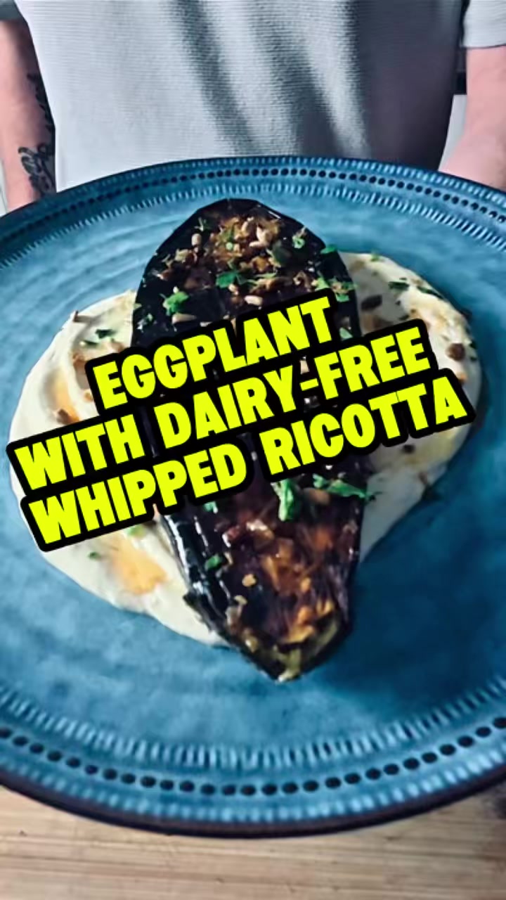Eggplant with Whipped Dairy-Free Ricotta

Want a tasty dish that’s actually quick and easy? Then my Eggplant with Whipped Dairy-Free Ricotta is the one!

Ingredients
• 1 eggplant
• Dairy-Free Ricotta (see my recipe)
• 2 tablespoons olive oil
• 3 tablespoons lemon juice
• 1 garlic clove, finely diced
• Honey
• Chilli oil (see my recipe)
• ½ teaspoon fresh parsley, finely diced
• 1 teaspoon toasted pine nuts
• Sea salt and cracked black pepper

⸻

Method
Start by getting out your high-speed blender.
Pour in your dairy-free ricotta — and if you haven’t made it yet, check out my recipe for that.
Add in 3 tablespoons of lemon juice, 2 tablespoons of olive oil, and your finely diced garlic.
Blend it up until it’s nice, creamy, and smooth. Then pop that to one side.

Now, grab your eggplant and cut it in half.
Get your cast iron skillet on medium to high heat.
On the flesh side of the eggplant, cut a criss-cross pattern, brush it with olive oil, and season with a bit of sea salt.
Pop it flesh side down into the skillet and cook until it’s got that lovely colour — it’ll release itself from the pan when it’s ready. Just keep an eye on the heat so it doesn’t burn.

While that’s cooking, toast your pine nuts in a dry pan until golden, and chop up your parsley.

To plate it up, spread about 3 tablespoons of your whipped dairy-free ricotta on the plate with the back of a spoon, making a nice swirl or circle.
Place your cooked eggplant right in the centre.
Drizzle over some honey, a bit of your chilli oil, sprinkle over the toasted pine nuts and parsley, and finish with a touch more sea salt and cracked black pepper.

And that’s it — simple, elegant, and absolutely bloody delicious. Enjoy!

#eggplantrecipes #whippedricottarecipes  #dairyfreerecipes #meatfreerecipes