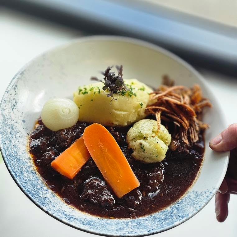 One of our favourite dishes on the lunch menu at The View Restaurant, available every Thursday and Friday, is my Lancashire Beef Stew with Gluten-Free Dumplings.

This dish takes me straight back to my childhood in Lancashire. It’s inspired by the stew my mum used to make, but with my own twist. The gluten-free dumplings are packed with Parmesan and fresh parsley, making them light, fluffy and full of flavour.

It’s served with creamy mash, baby carrots, baby onions, and crispy potato skins for that perfect bit of crunch. It’s proper comfort food, completely gluten-free, and perfect for these cooler days.

If you’re in Albany, come and give it a try. I think you’ll see why it’s become one of my favourites.

#beefstew #dumplings #glutenfree #lunch